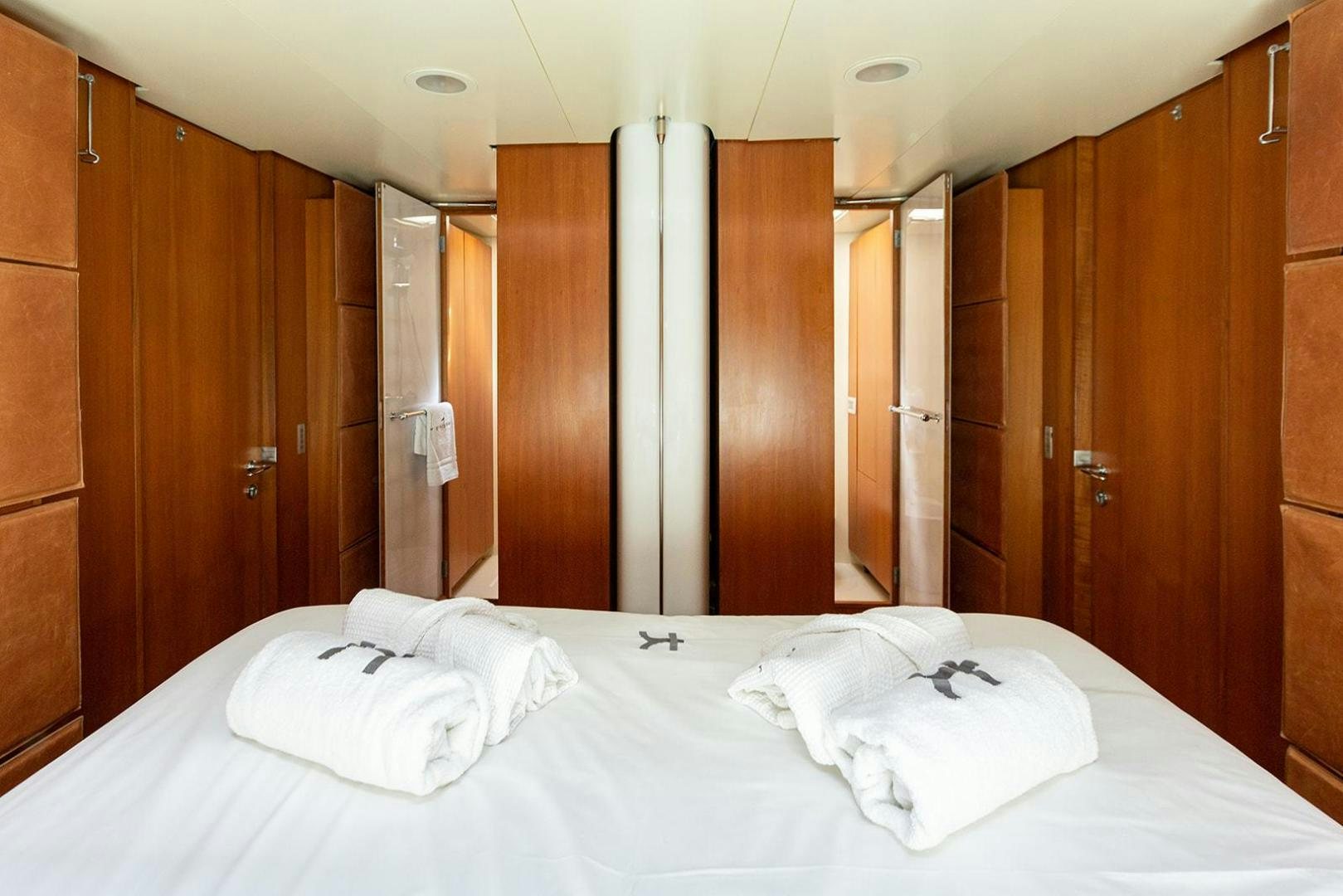 a room with a bed and cabinets aboard KENORA Yacht for Sale