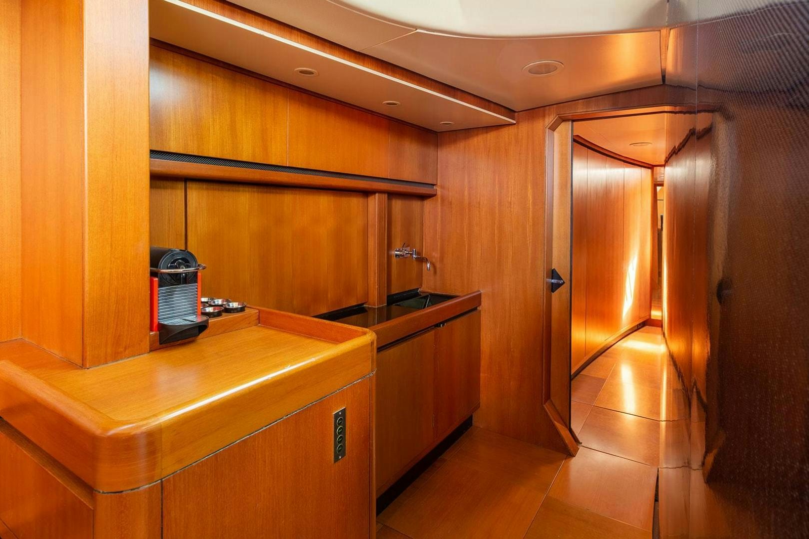 a kitchen with wooden cabinets aboard KENORA Yacht for Sale