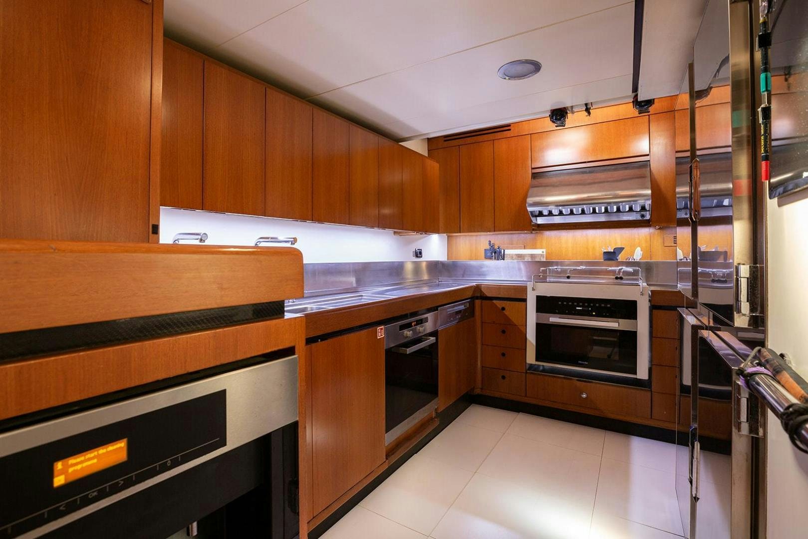 a kitchen with wooden cabinets aboard KENORA Yacht for Sale