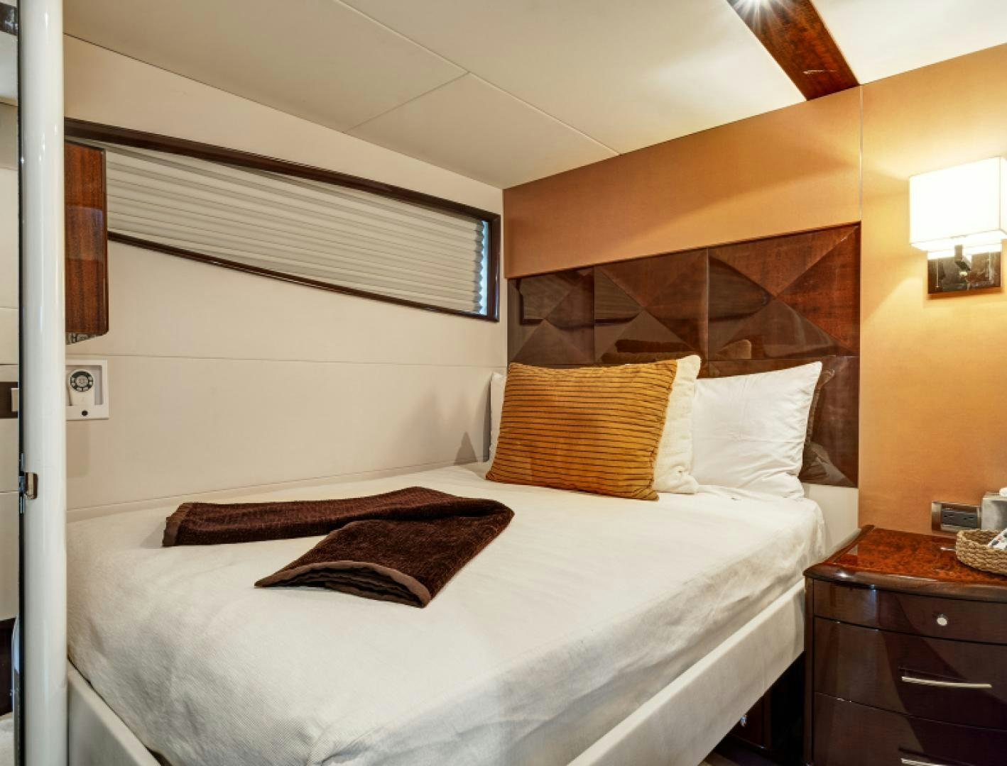 a bed with a white sheet and pillows aboard LADY H Yacht for Sale