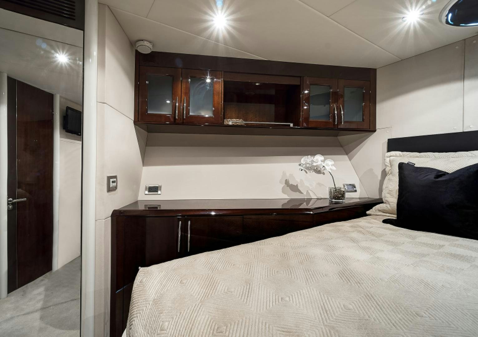 a bed with a white bed spread aboard LADY H Yacht for Sale