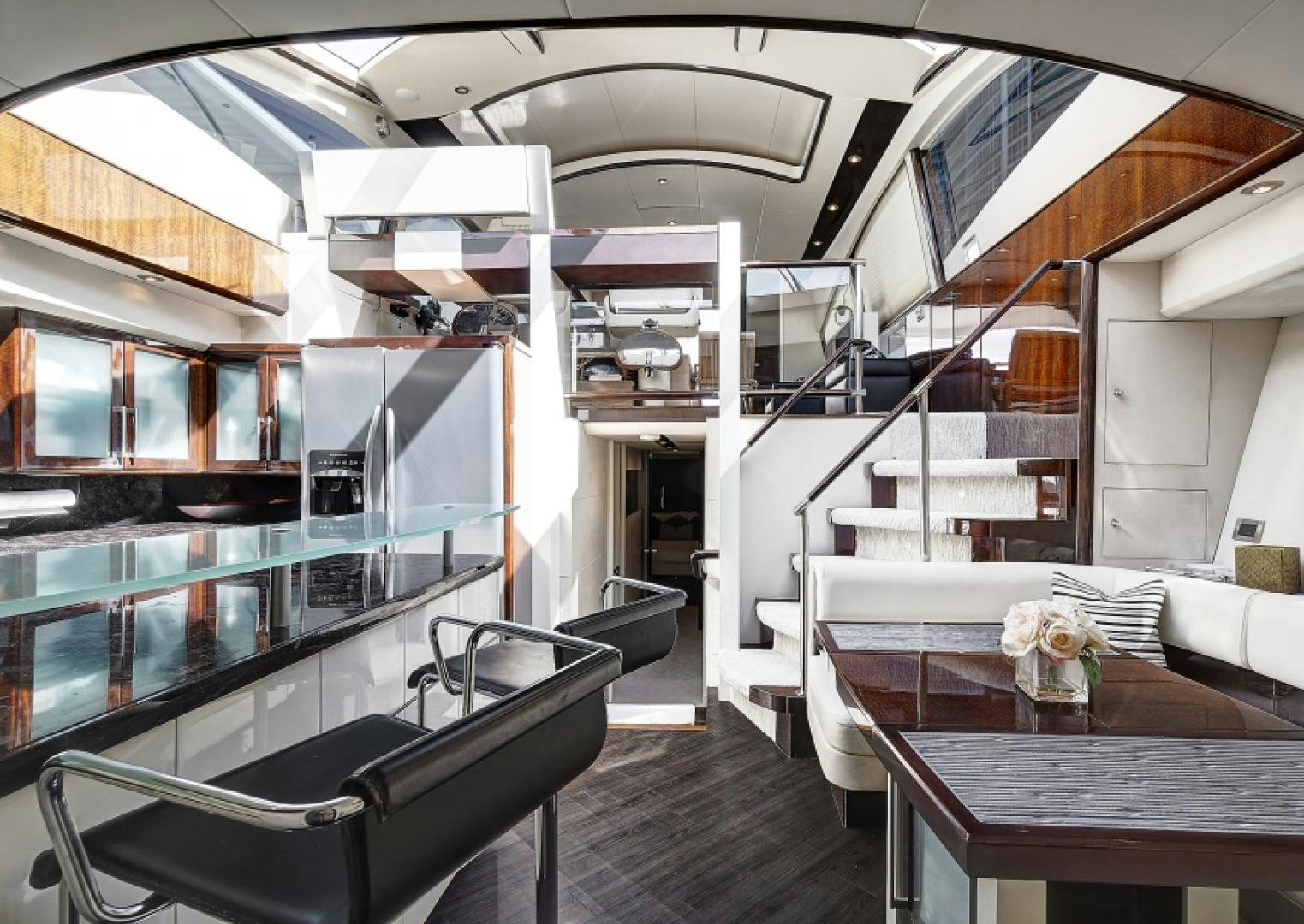 a room with a table chairs and a staircase aboard LADY H Yacht for Sale