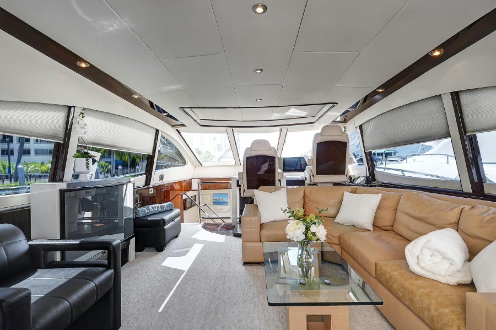 a living room with a couch and a television aboard LADY H Yacht for Sale