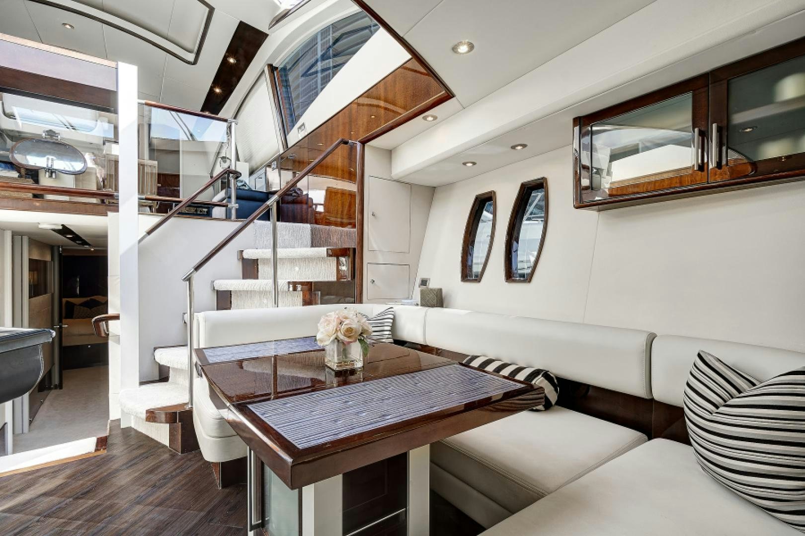 a room with a table and chairs aboard LADY H Yacht for Sale
