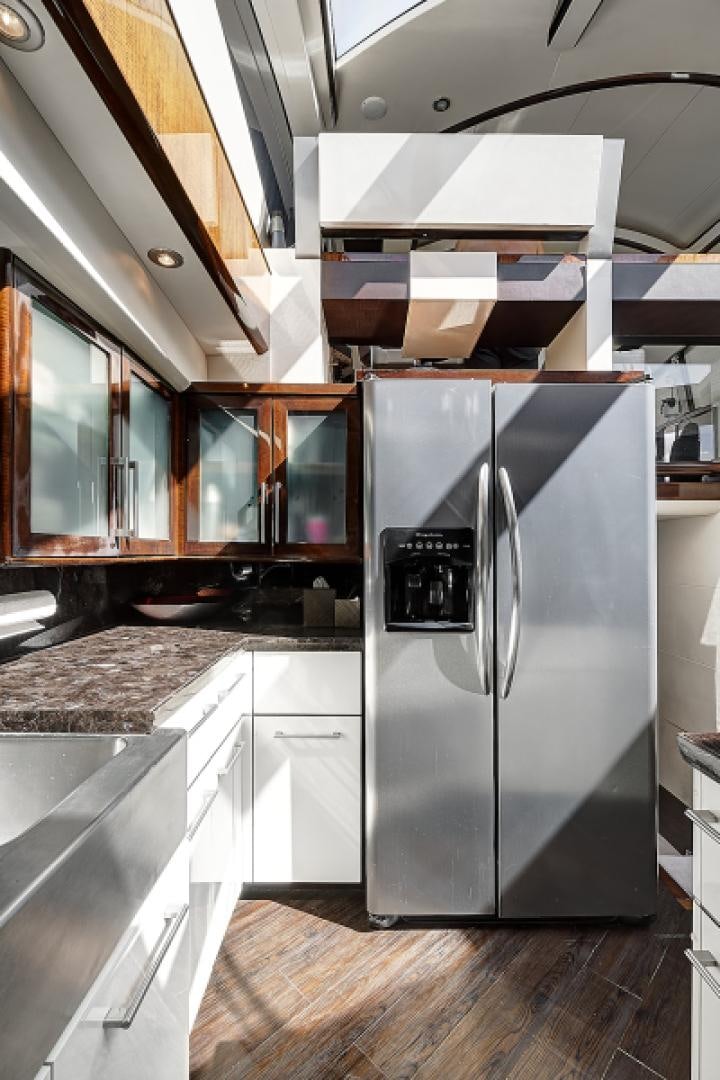 a kitchen with a stainless steel refrigerator aboard LADY H Yacht for Sale