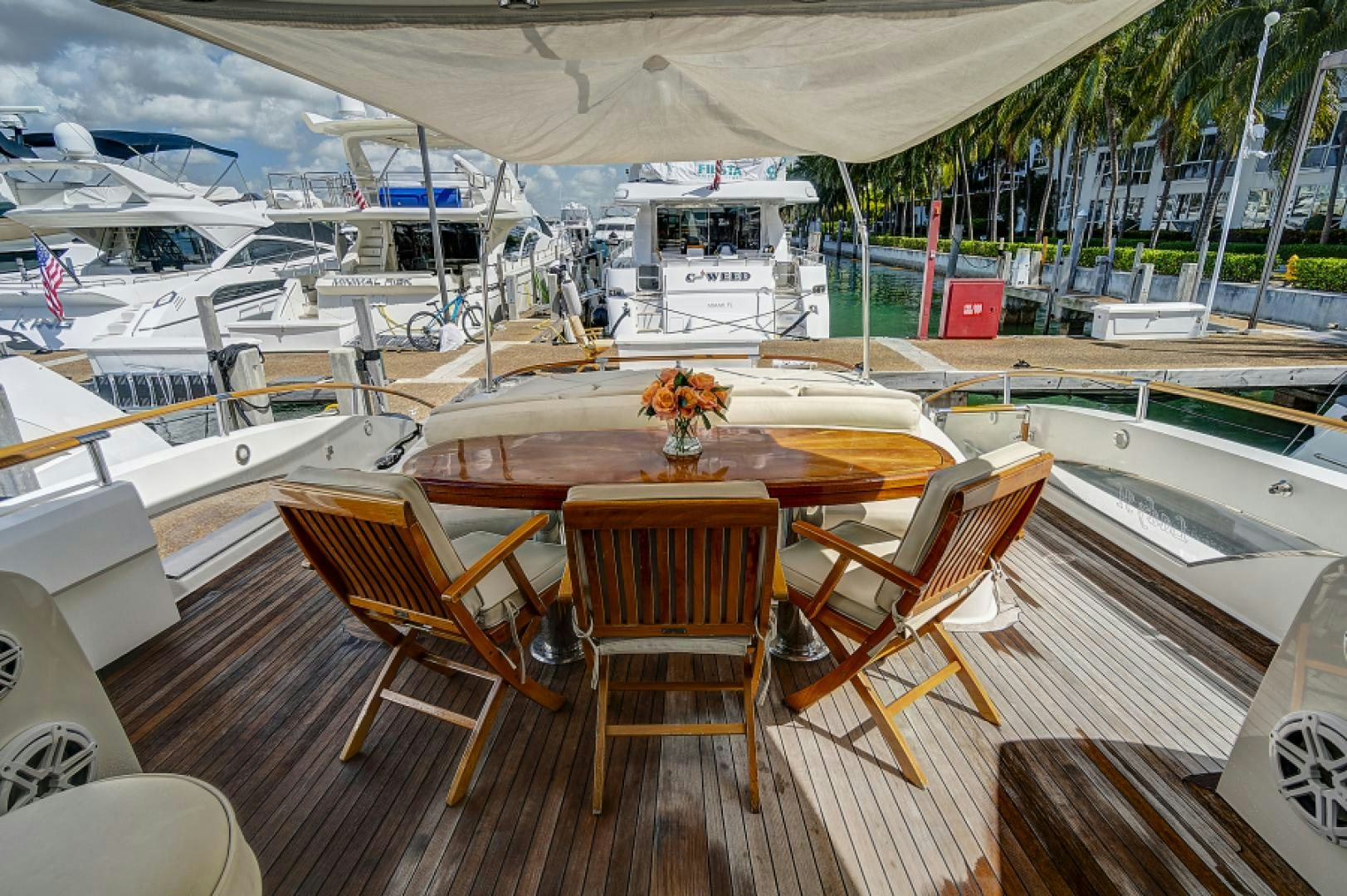 a deck with chairs and tables on it aboard LADY H Yacht for Sale