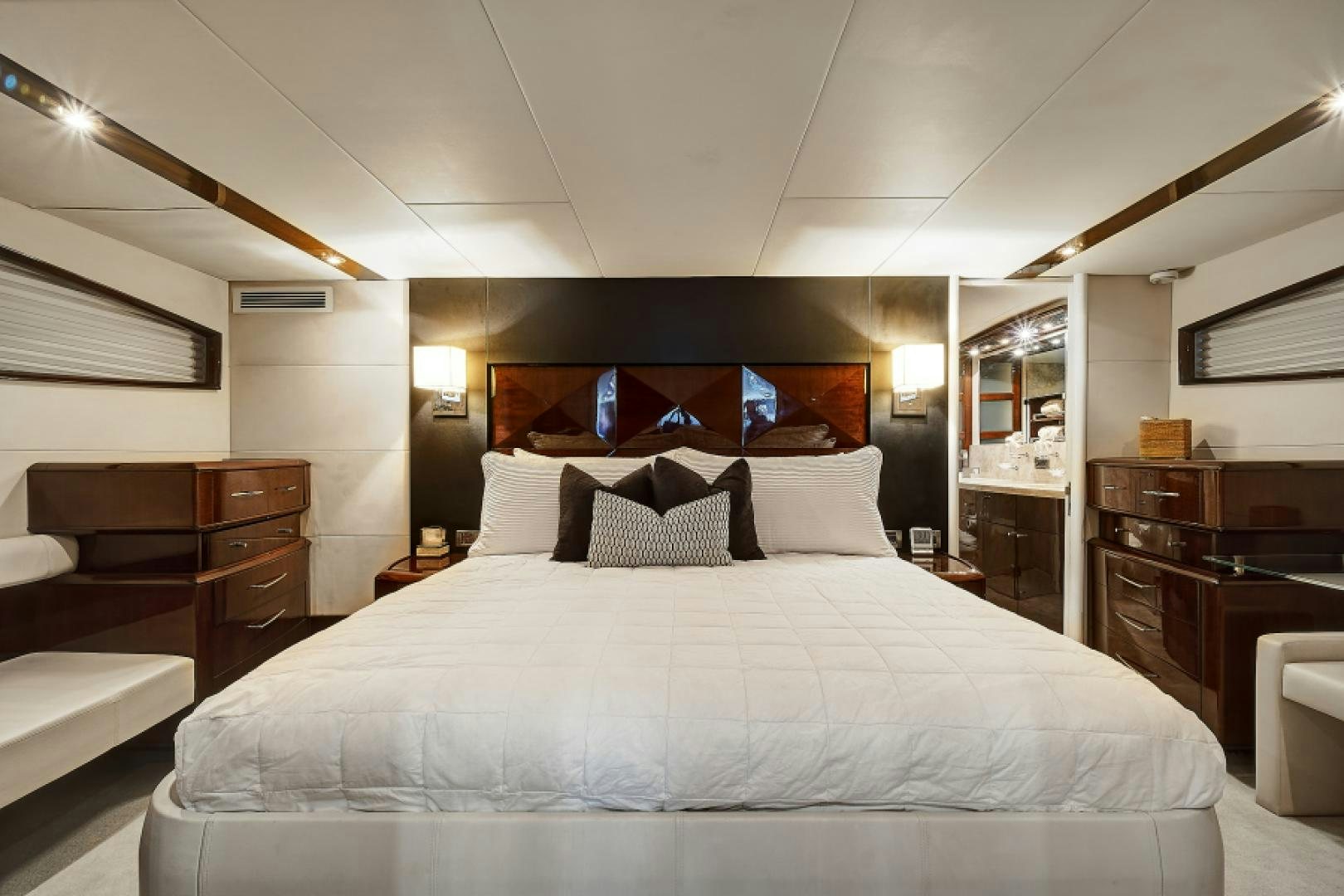 a bed with white sheets aboard LADY H Yacht for Sale