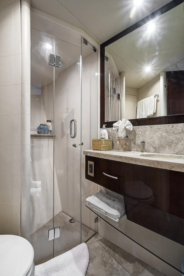 a bathroom with a glass shower aboard LADY H Yacht for Sale