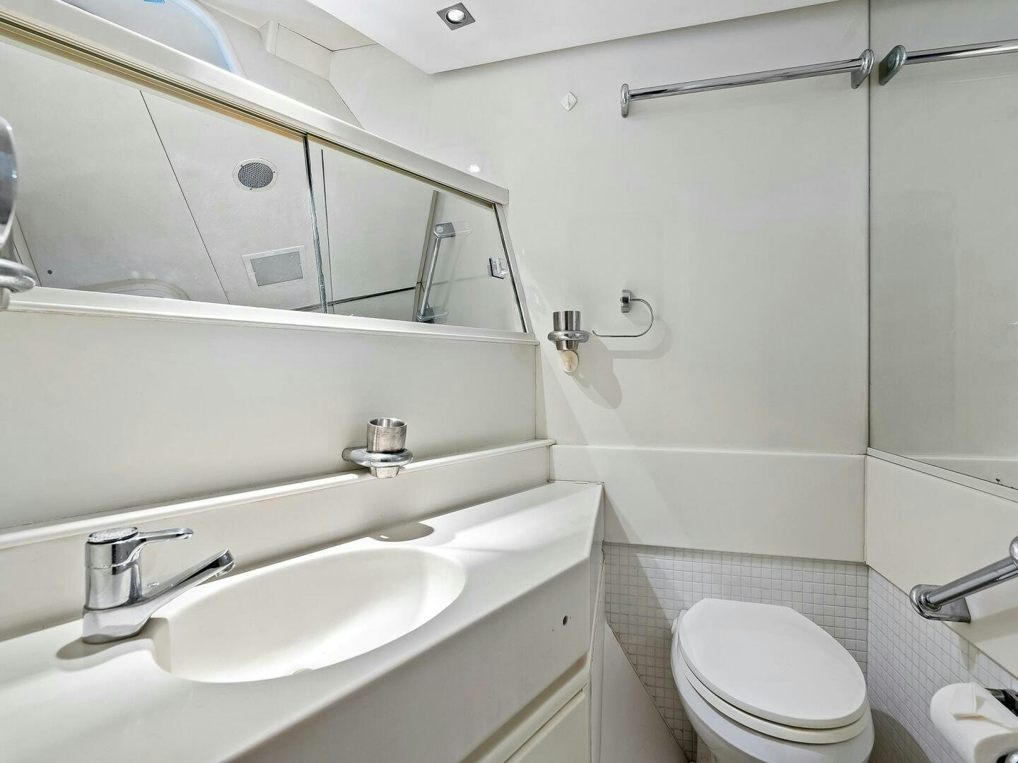 a bathroom with a toilet and sink aboard SIENNA Yacht for Sale