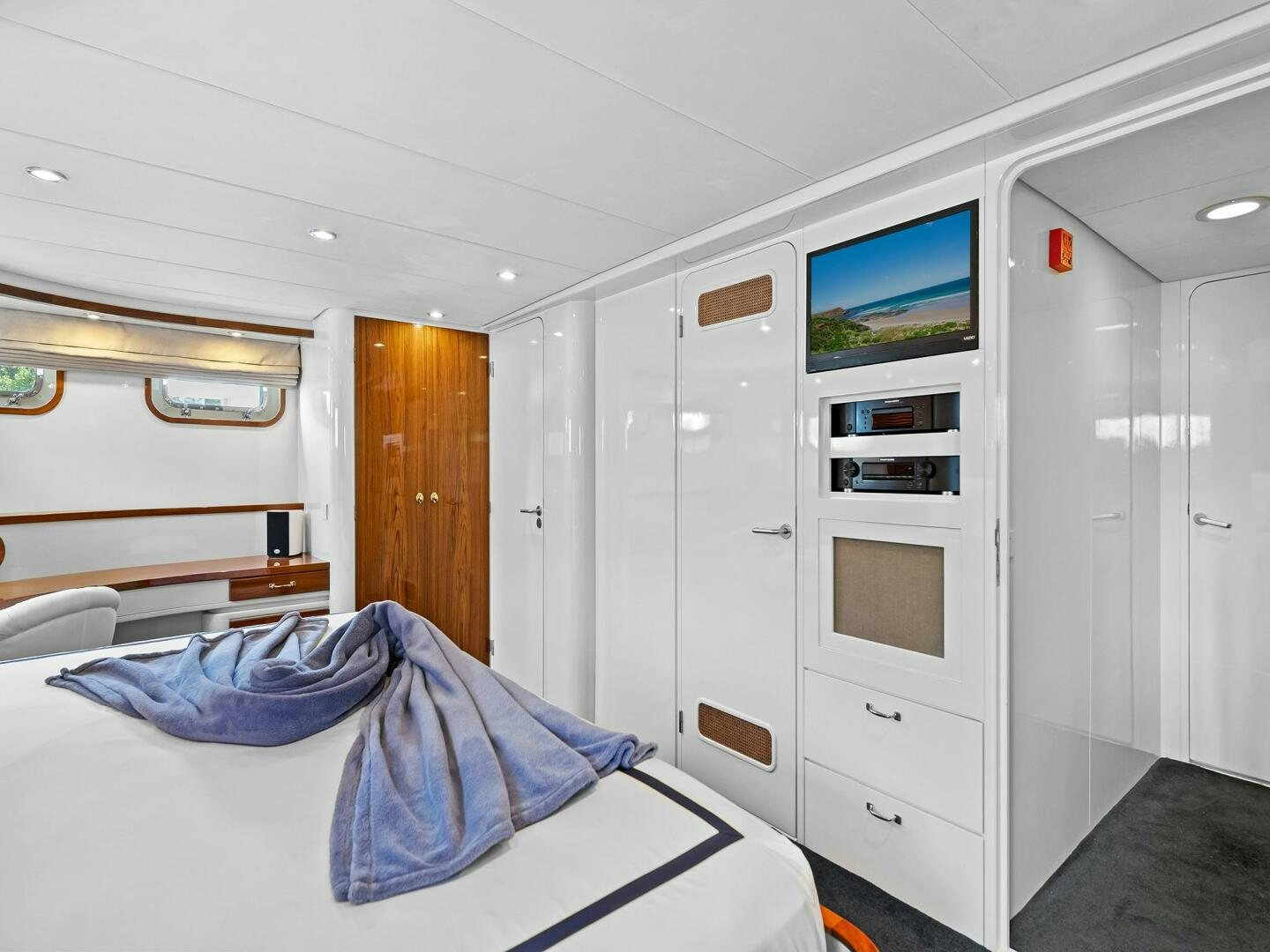 a bedroom with a bed and a television aboard SIENNA Yacht for Sale