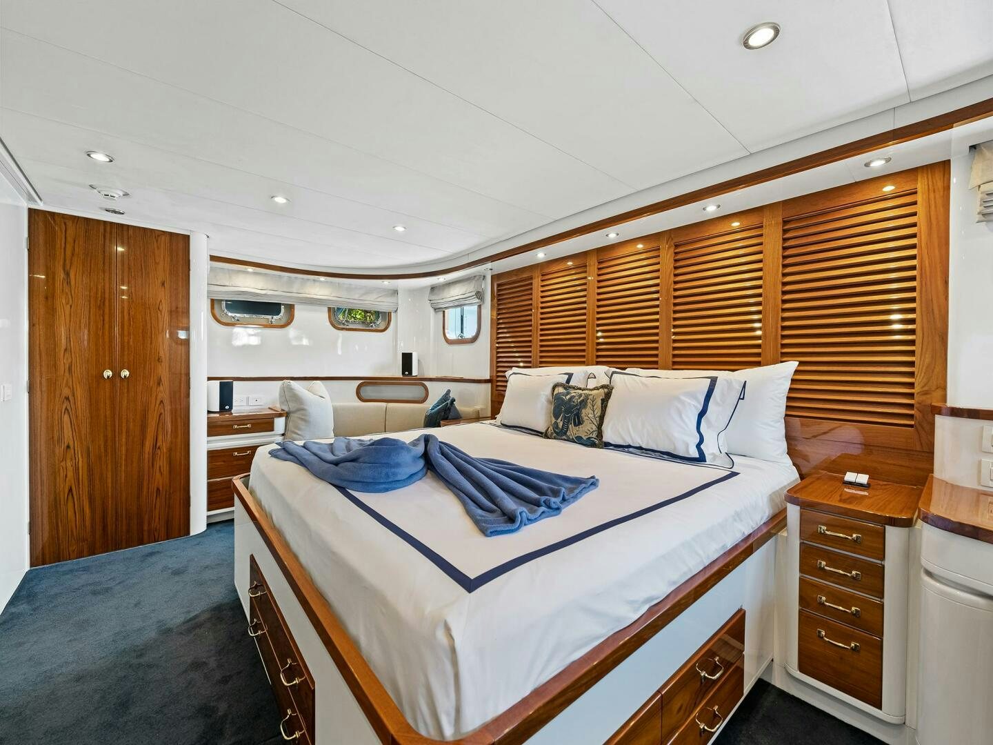 a room with a bed and a dresser aboard SIENNA Yacht for Sale