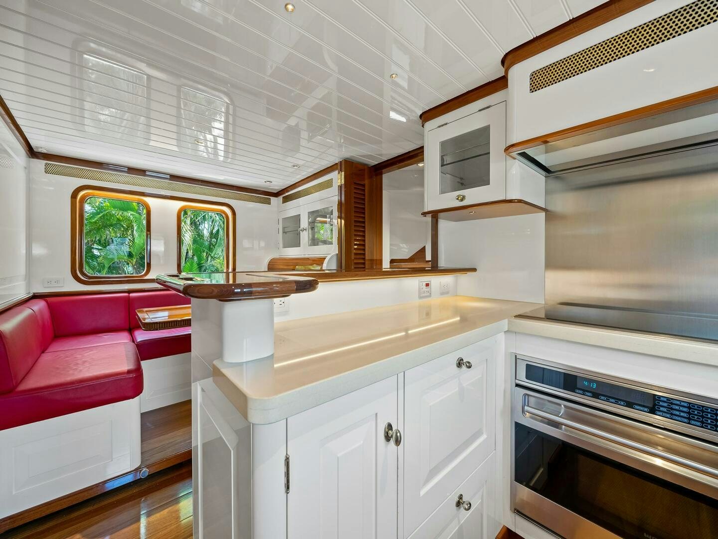 a kitchen with a table and a couch aboard SIENNA Yacht for Sale