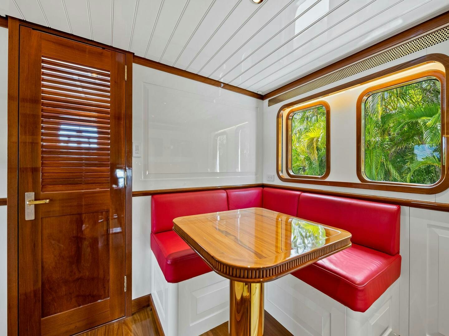 a table and chairs in a room aboard SIENNA Yacht for Sale