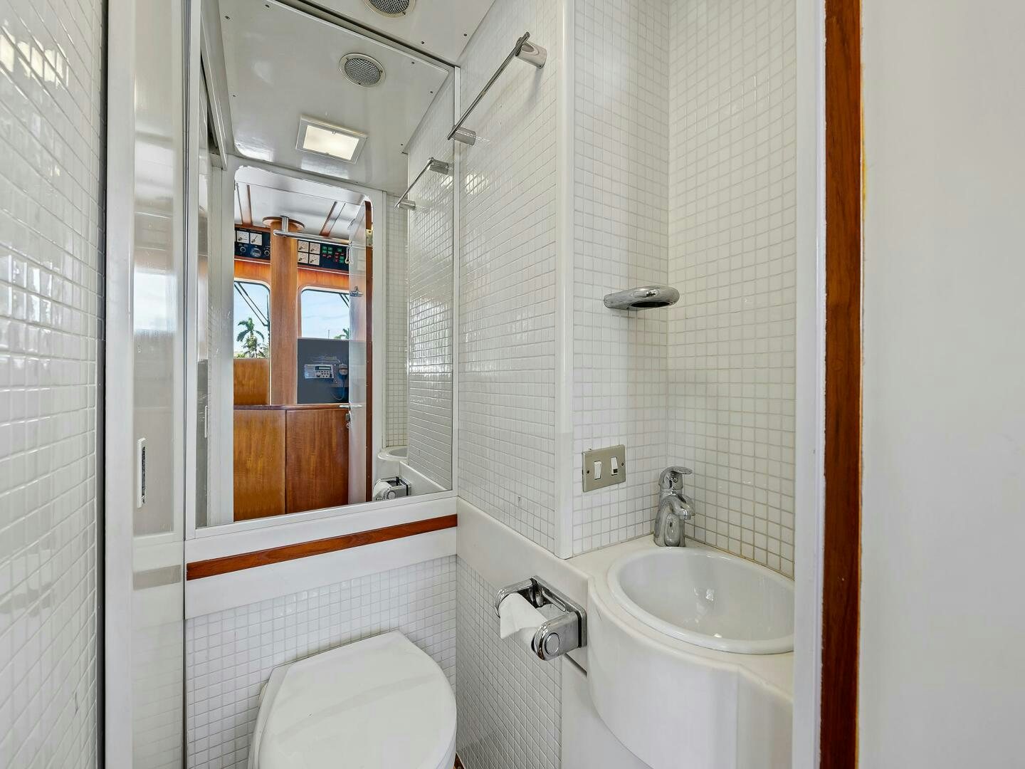 a bathroom with a sink and a mirror aboard SIENNA Yacht for Sale