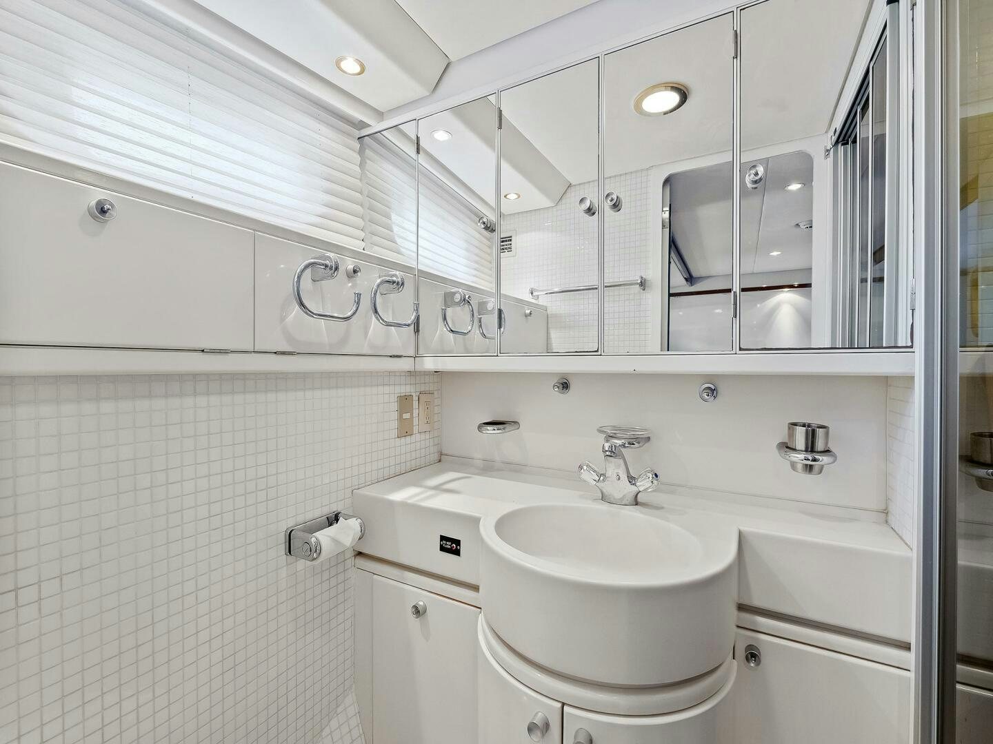 a bathroom with a sink and a mirror aboard SIENNA Yacht for Sale