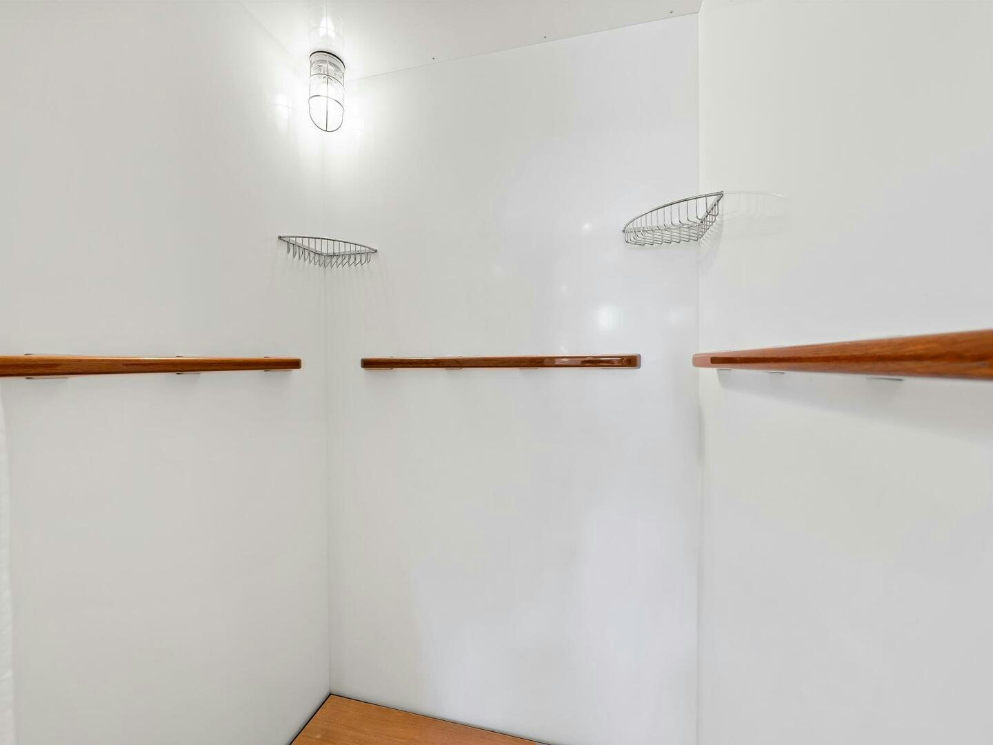 a white wall with a wooden handle aboard SIENNA Yacht for Sale