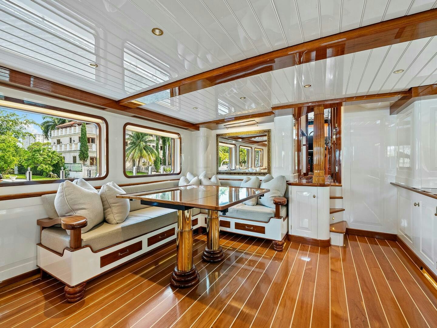 a living room with a table and couches aboard SIENNA Yacht for Sale