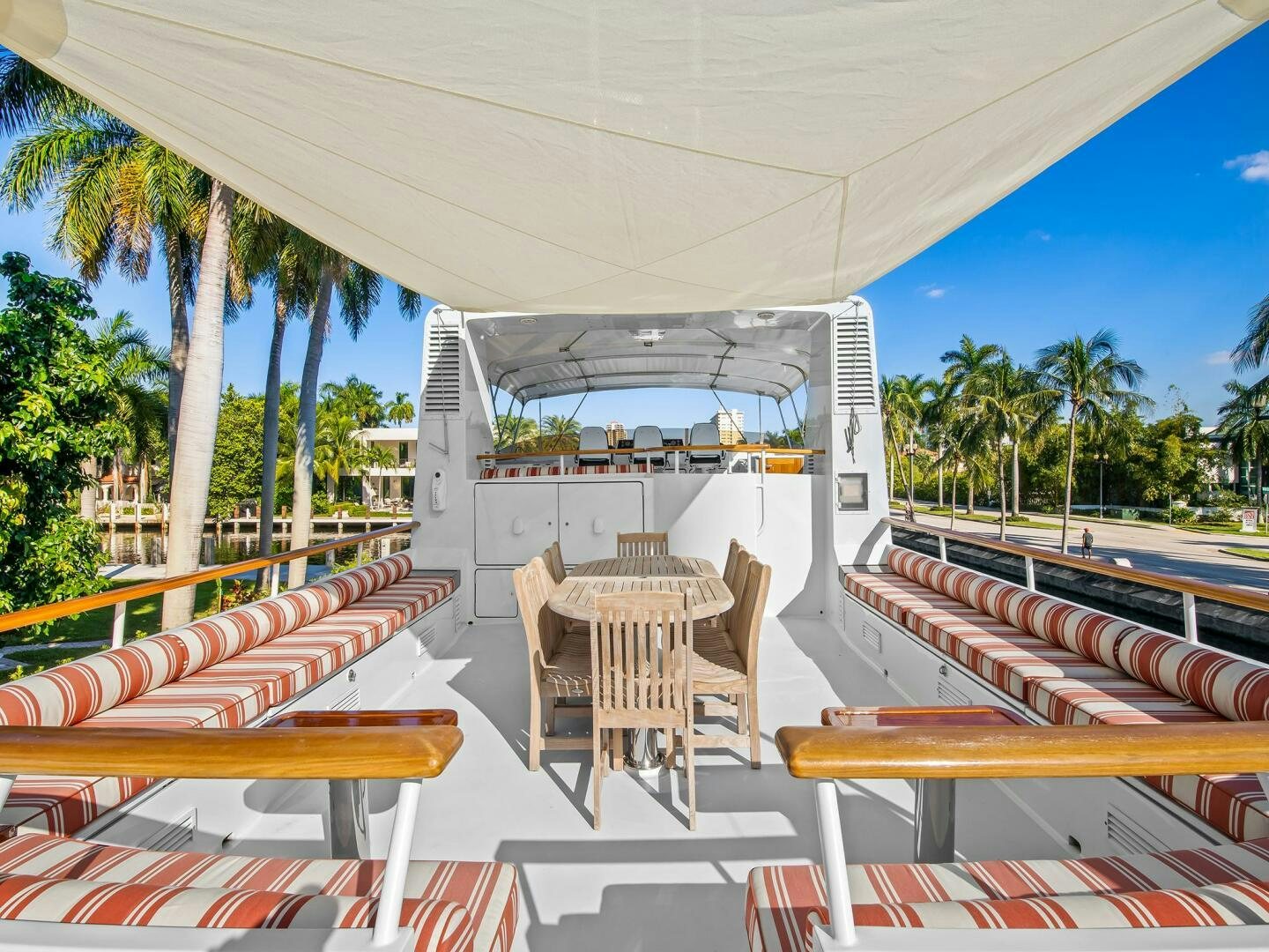a patio with tables and chairs aboard SIENNA Yacht for Sale