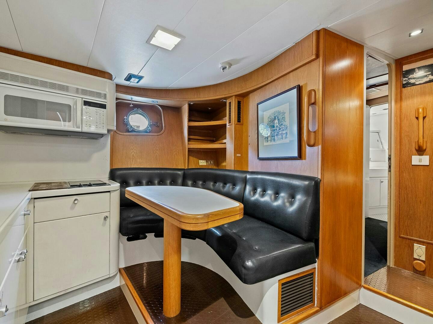 a kitchen with a bar and stool aboard SIENNA Yacht for Sale