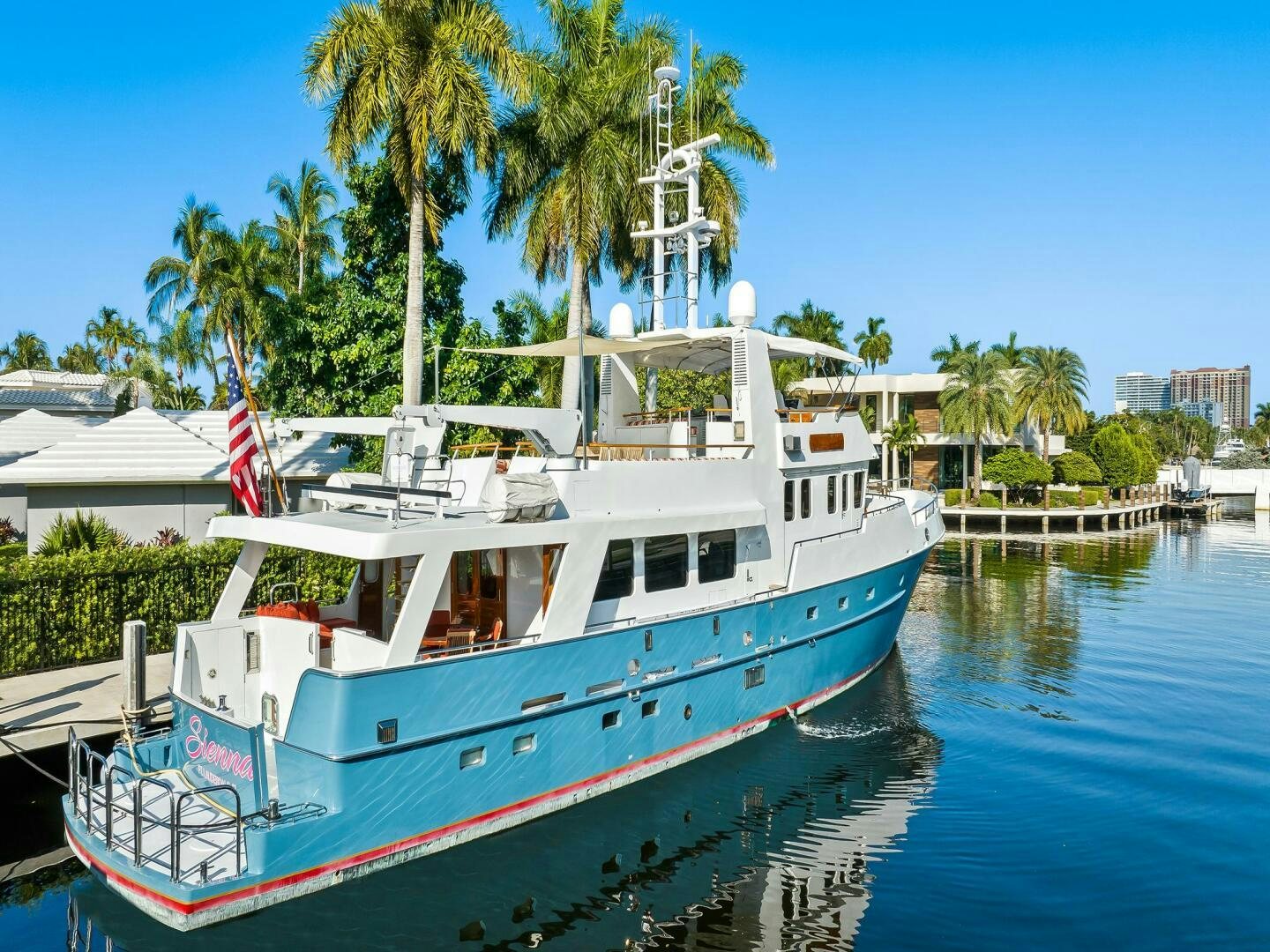 a large white boat docked at a pier aboard SIENNA Yacht for Sale