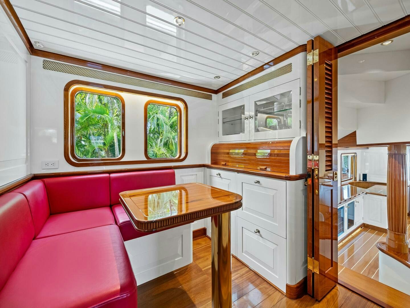 a living room with a pink couch and a table aboard SIENNA Yacht for Sale