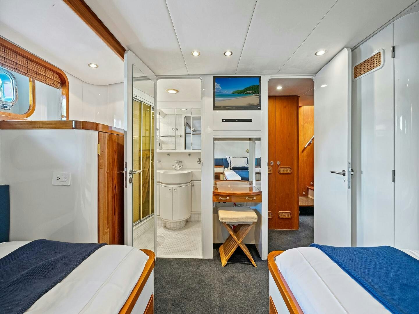 a room with a bed and a desk aboard SIENNA Yacht for Sale