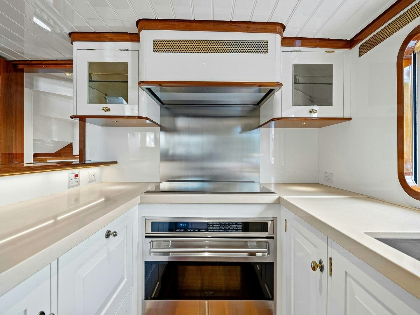 a kitchen with a stove and cabinets aboard SIENNA Yacht for Sale