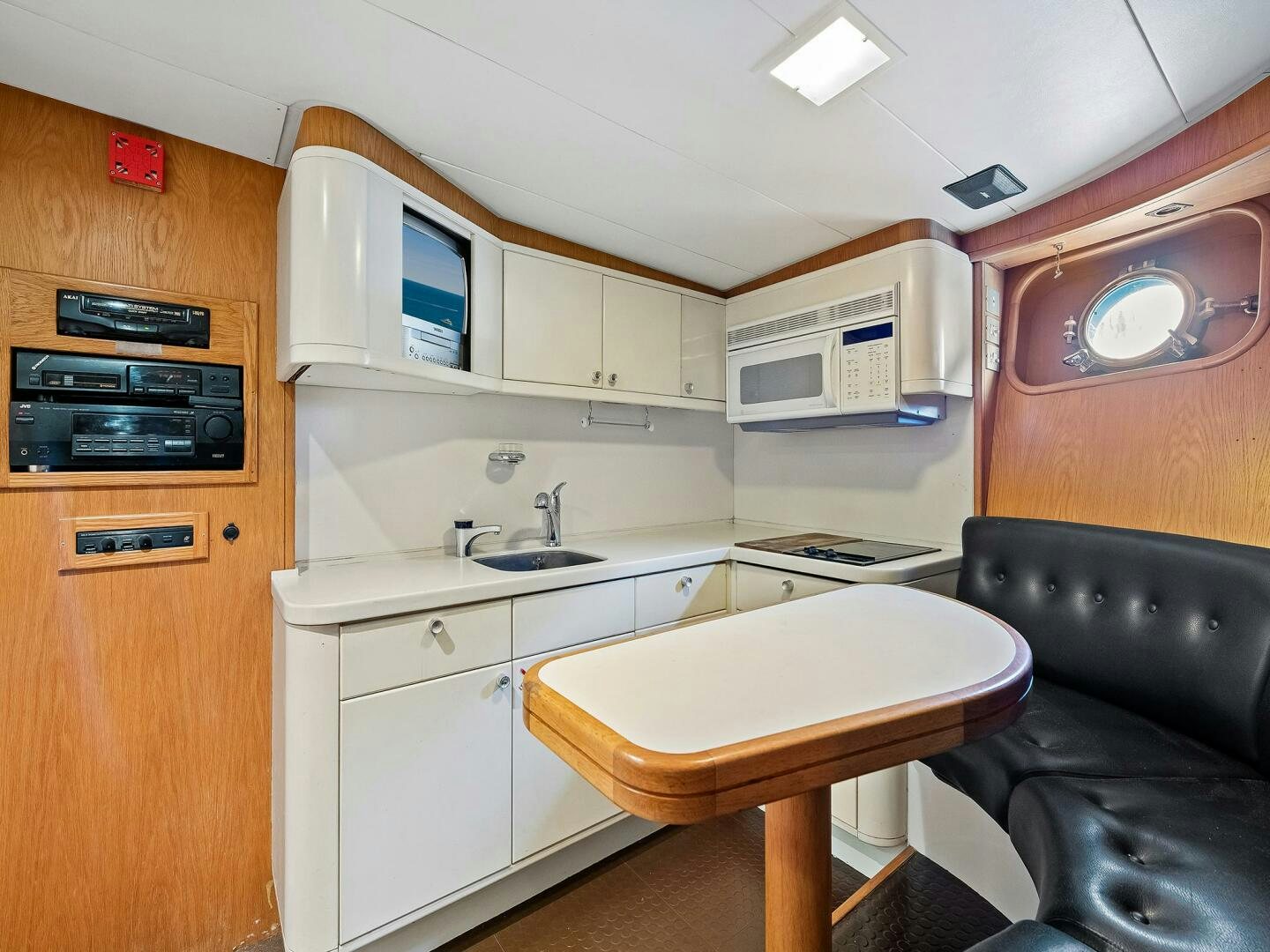 a small kitchen with a table aboard SIENNA Yacht for Sale