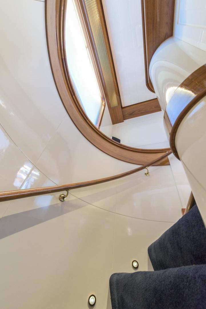 a mirror above a blue couch aboard SIENNA Yacht for Sale