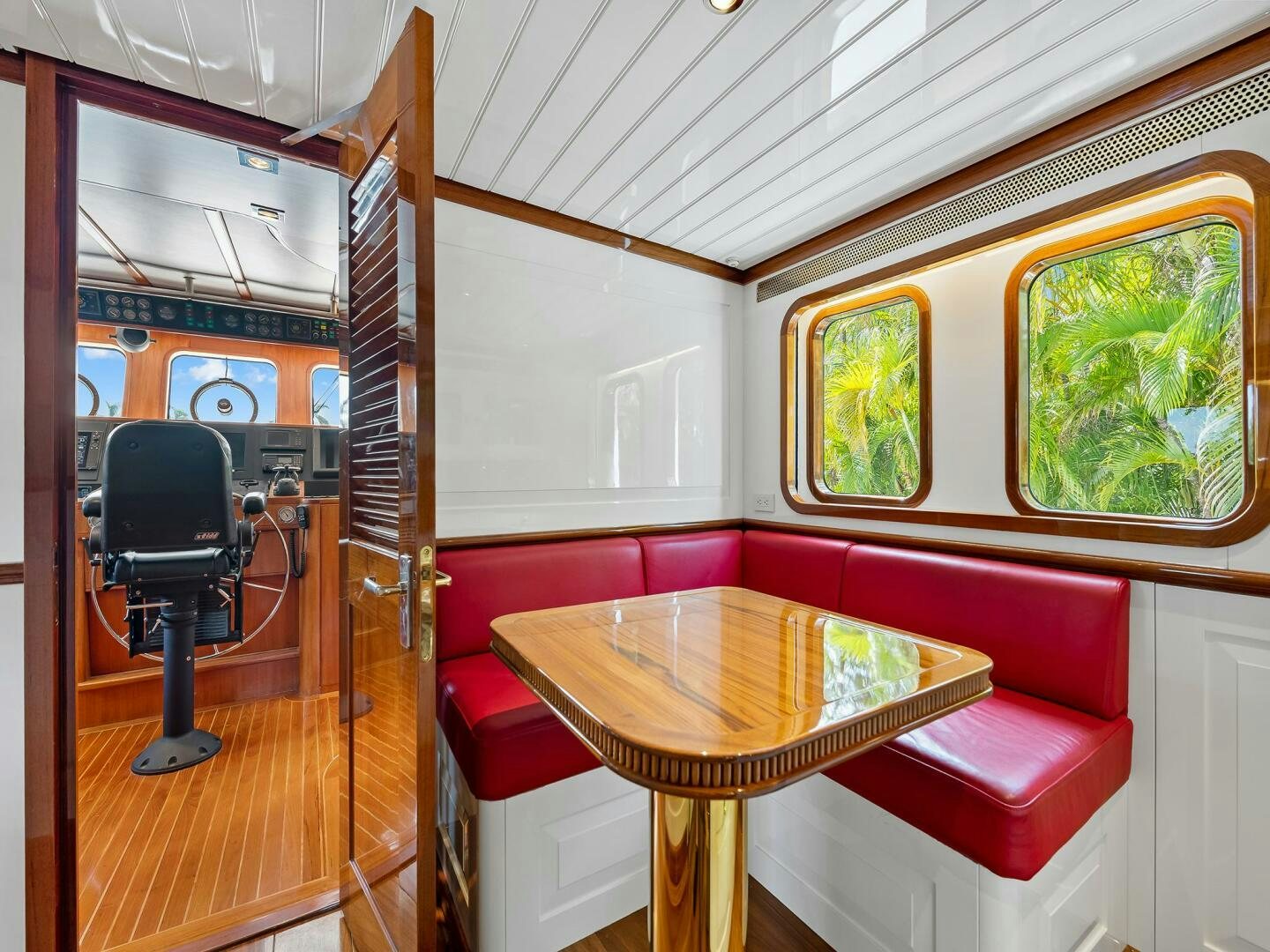 a room with a table and chairs aboard SIENNA Yacht for Sale