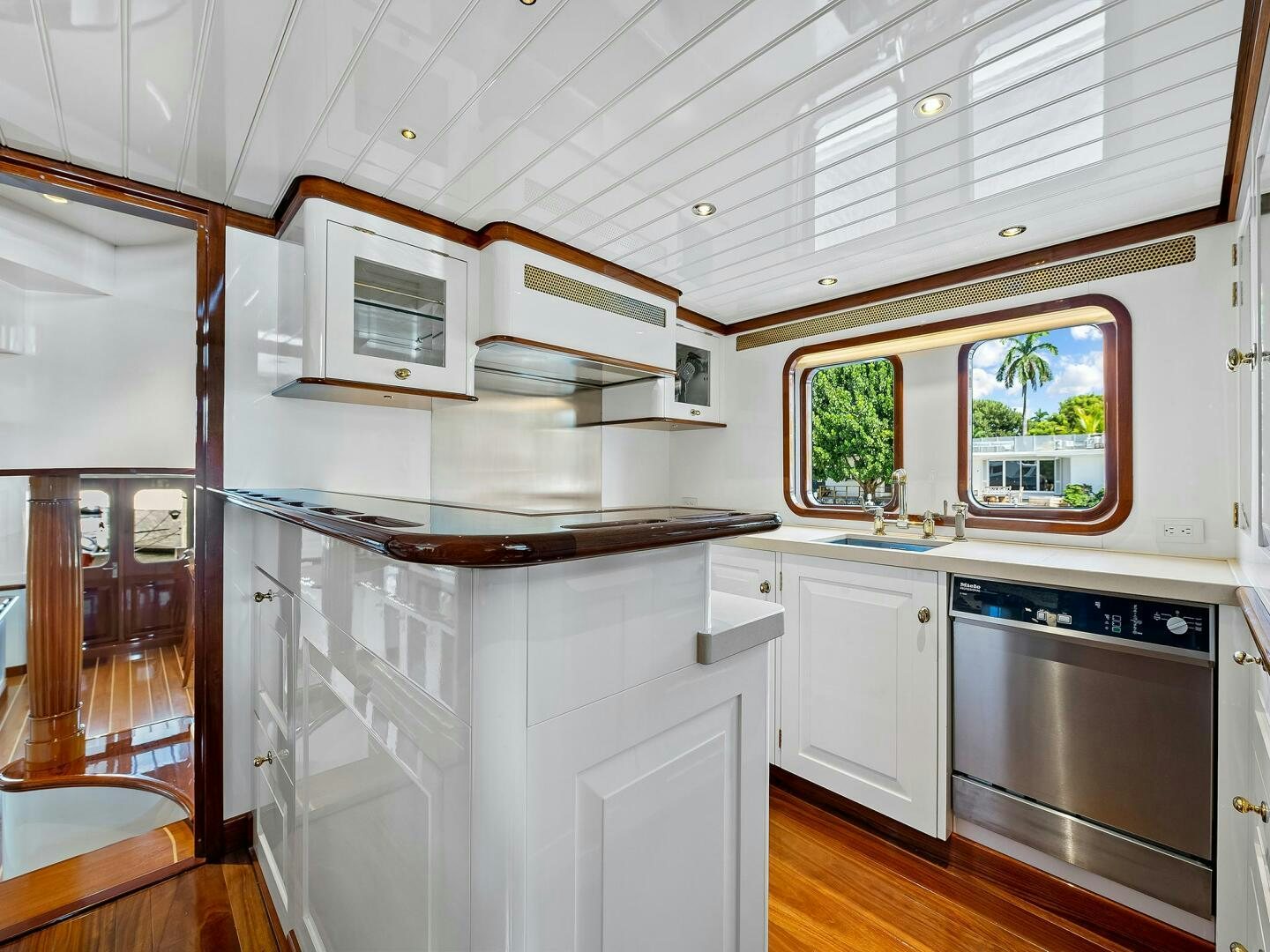 a kitchen with white cabinets aboard SIENNA Yacht for Sale