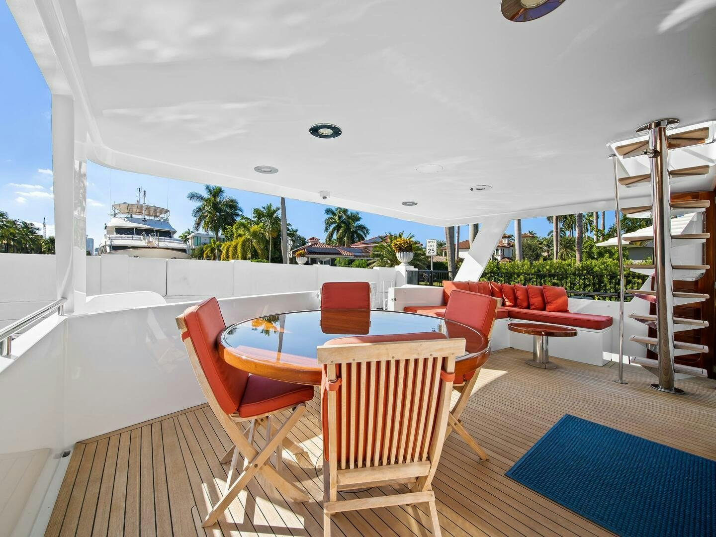 a deck with a table and chairs aboard SIENNA Yacht for Sale