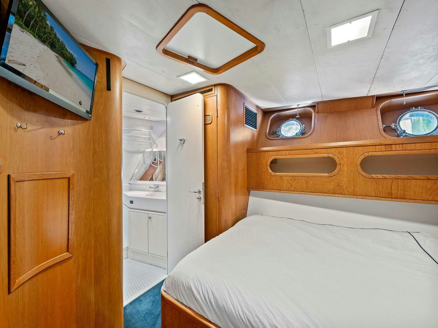 a small bedroom with a bed aboard SIENNA Yacht for Sale