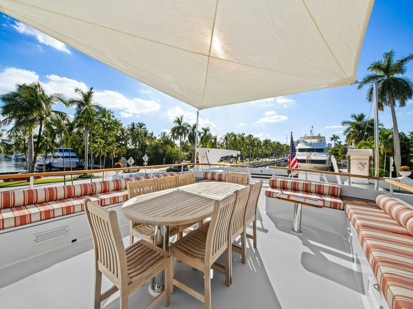 a patio with tables and chairs aboard SIENNA Yacht for Sale
