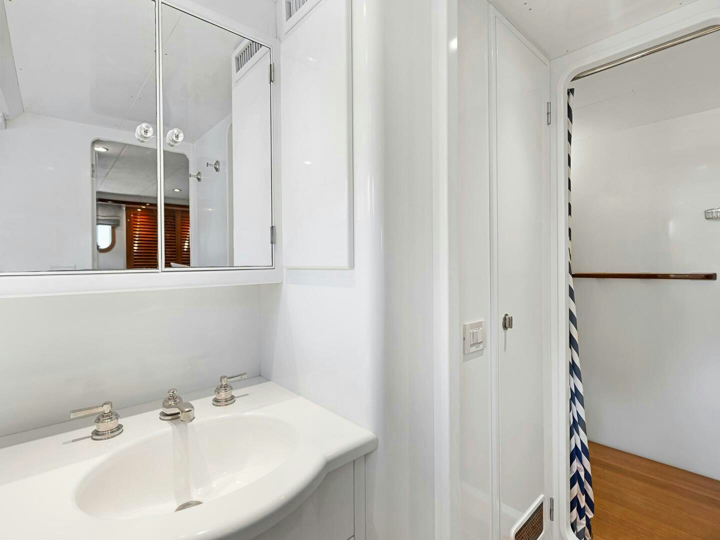 a bathroom with a sink and mirror aboard SIENNA Yacht for Sale