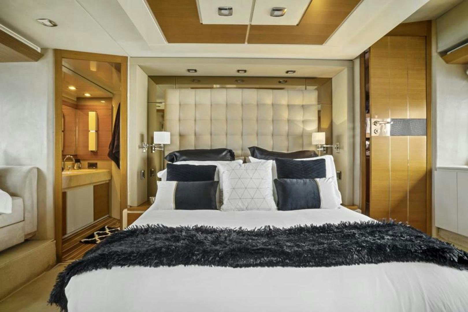 a large bed with black and white sheets aboard WICKED Yacht for Sale