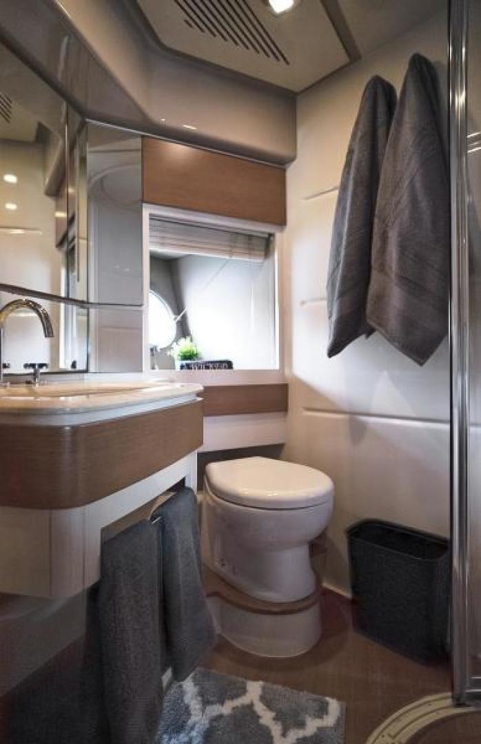 a bathroom with a toilet sink and a mirror aboard WICKED Yacht for Sale