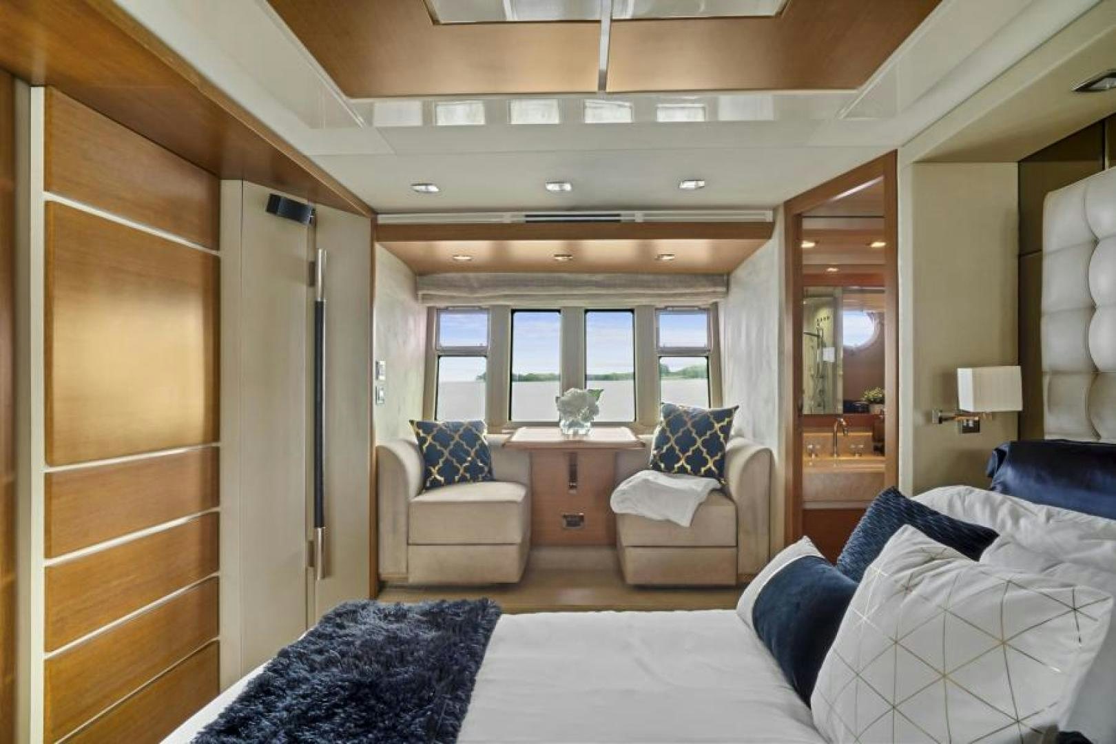 a room with a bed and a chair aboard WICKED Yacht for Sale