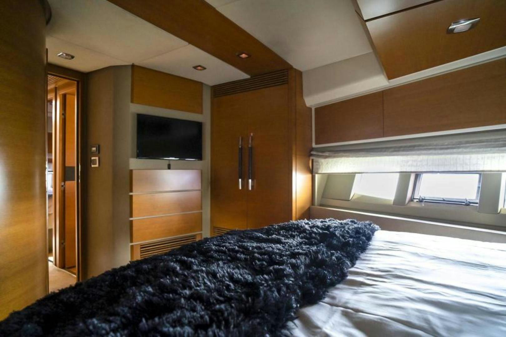 a bedroom with a bed and a television aboard WICKED Yacht for Sale