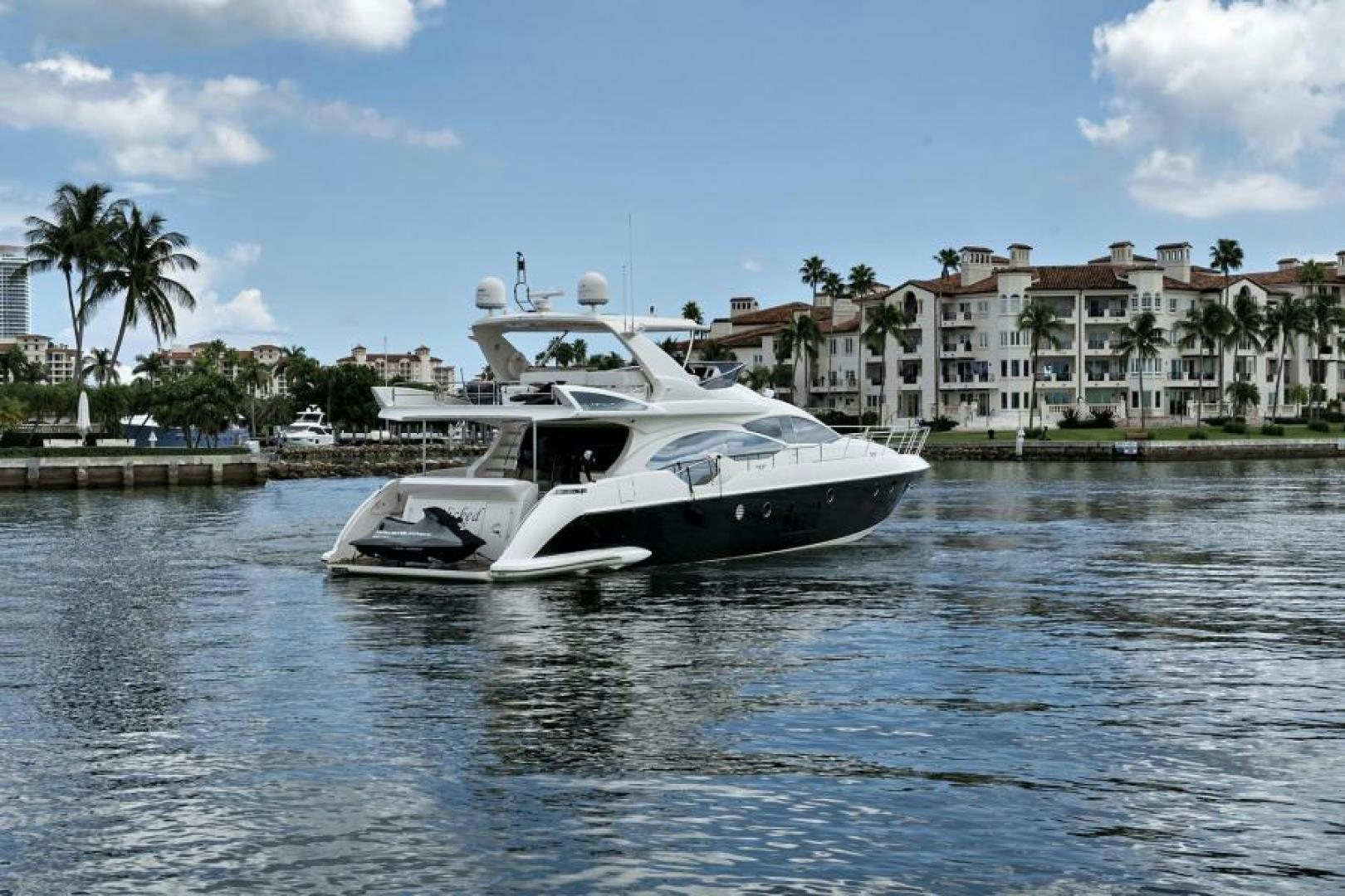 a white boat on the water aboard WICKED Yacht for Sale