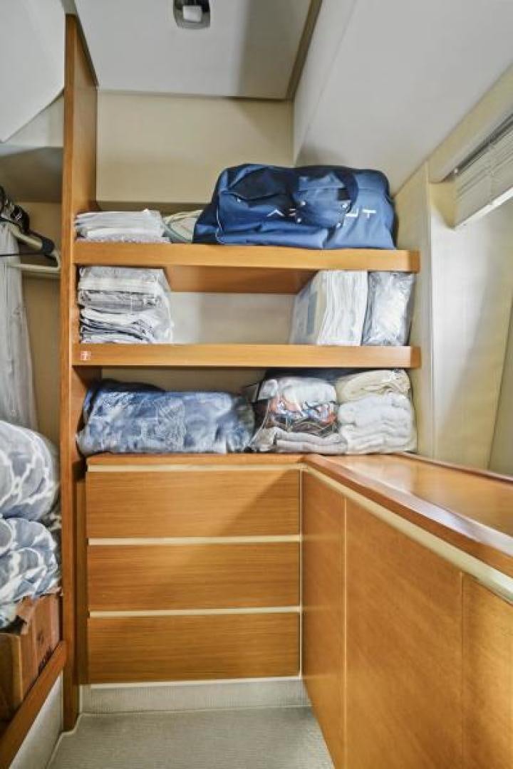 a closet with clothes on it aboard WICKED Yacht for Sale