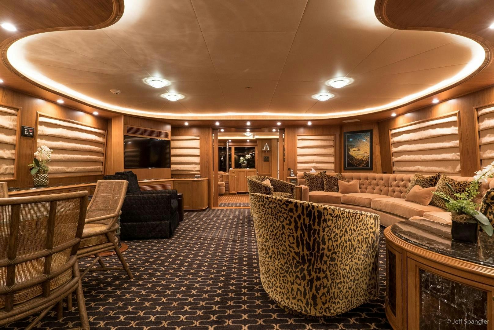 a living room with couches and chairs aboard LIFE OF RILEY Yacht for Sale