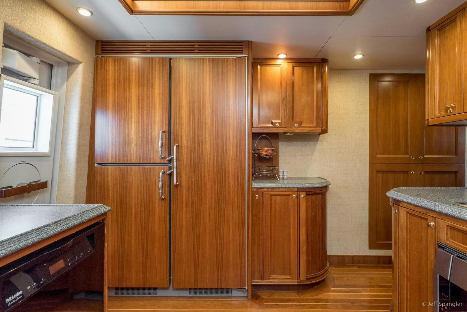 a kitchen with wooden cabinets aboard LIFE OF RILEY Yacht for Sale