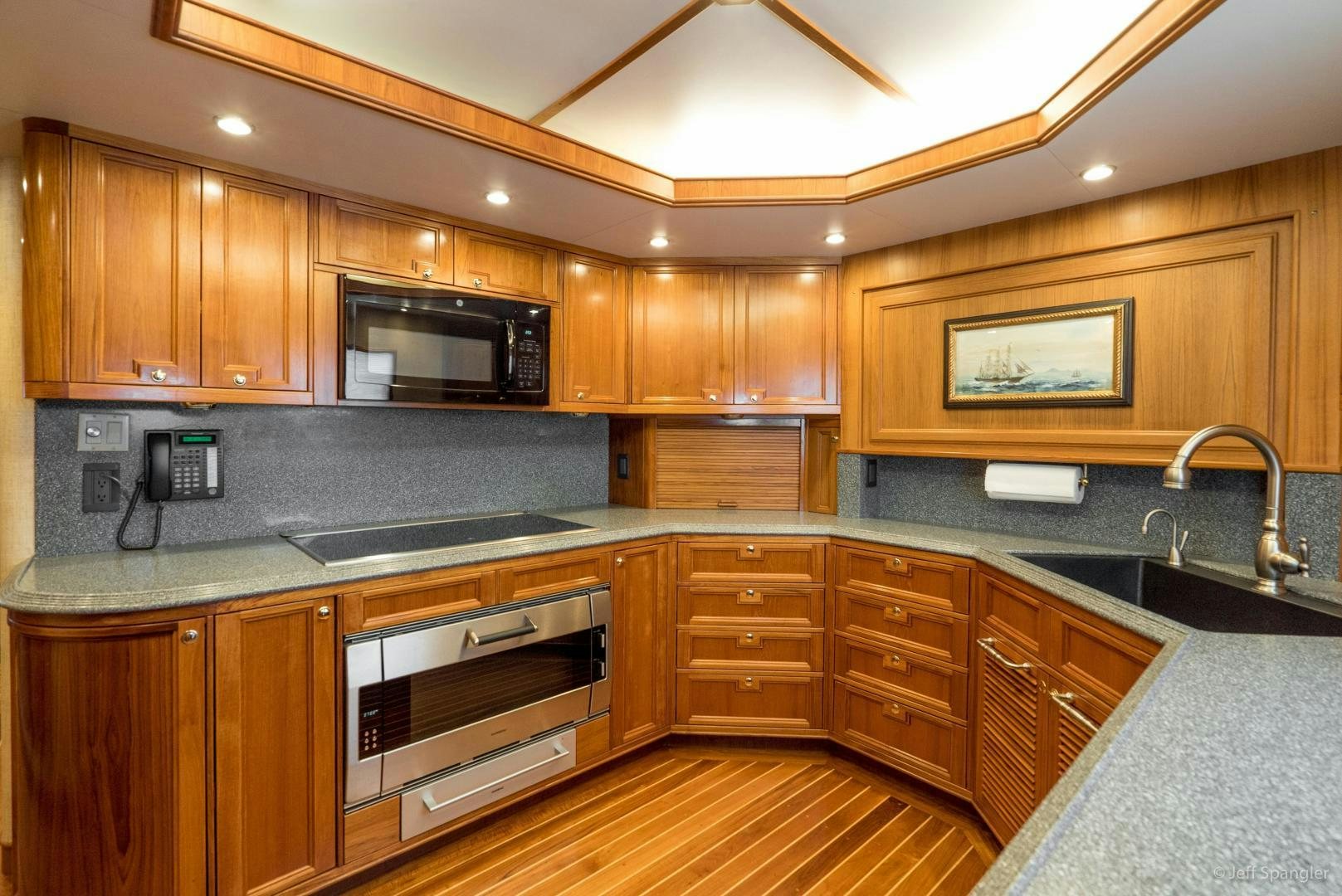 a kitchen with wooden cabinets aboard LIFE OF RILEY Yacht for Sale
