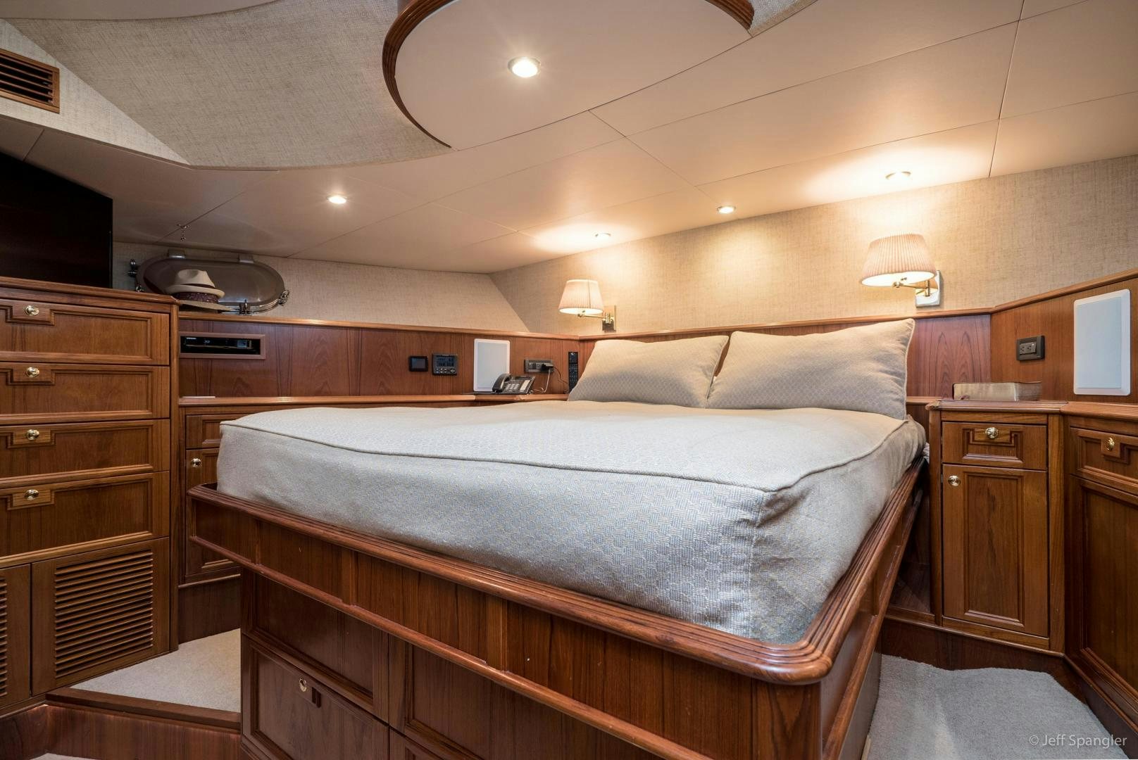 a bedroom with a bed and a dresser aboard LIFE OF RILEY Yacht for Sale