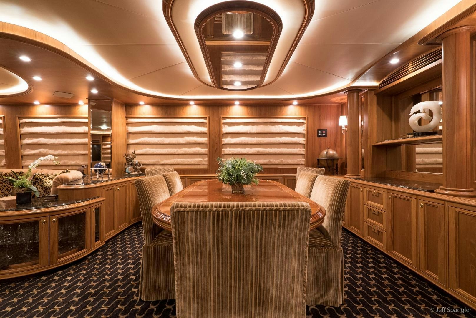 a large room with a table and chairs aboard LIFE OF RILEY Yacht for Sale