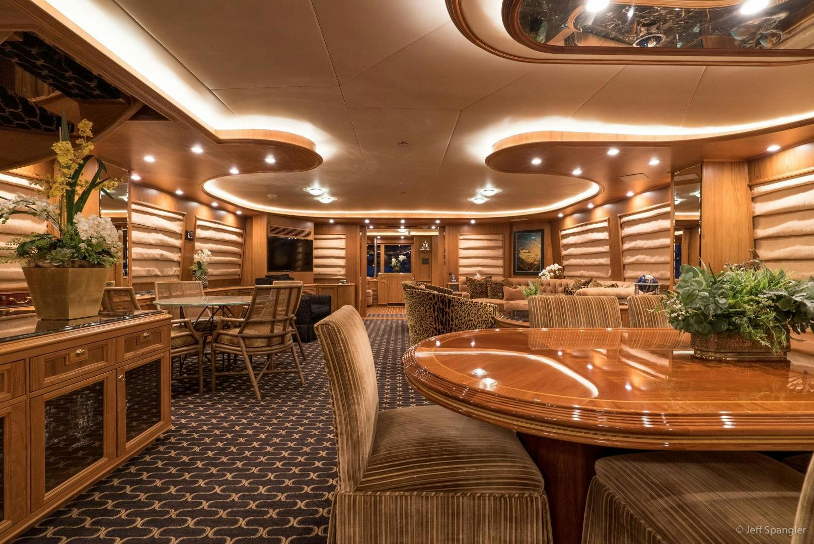 a large room with tables and chairs aboard LIFE OF RILEY Yacht for Sale
