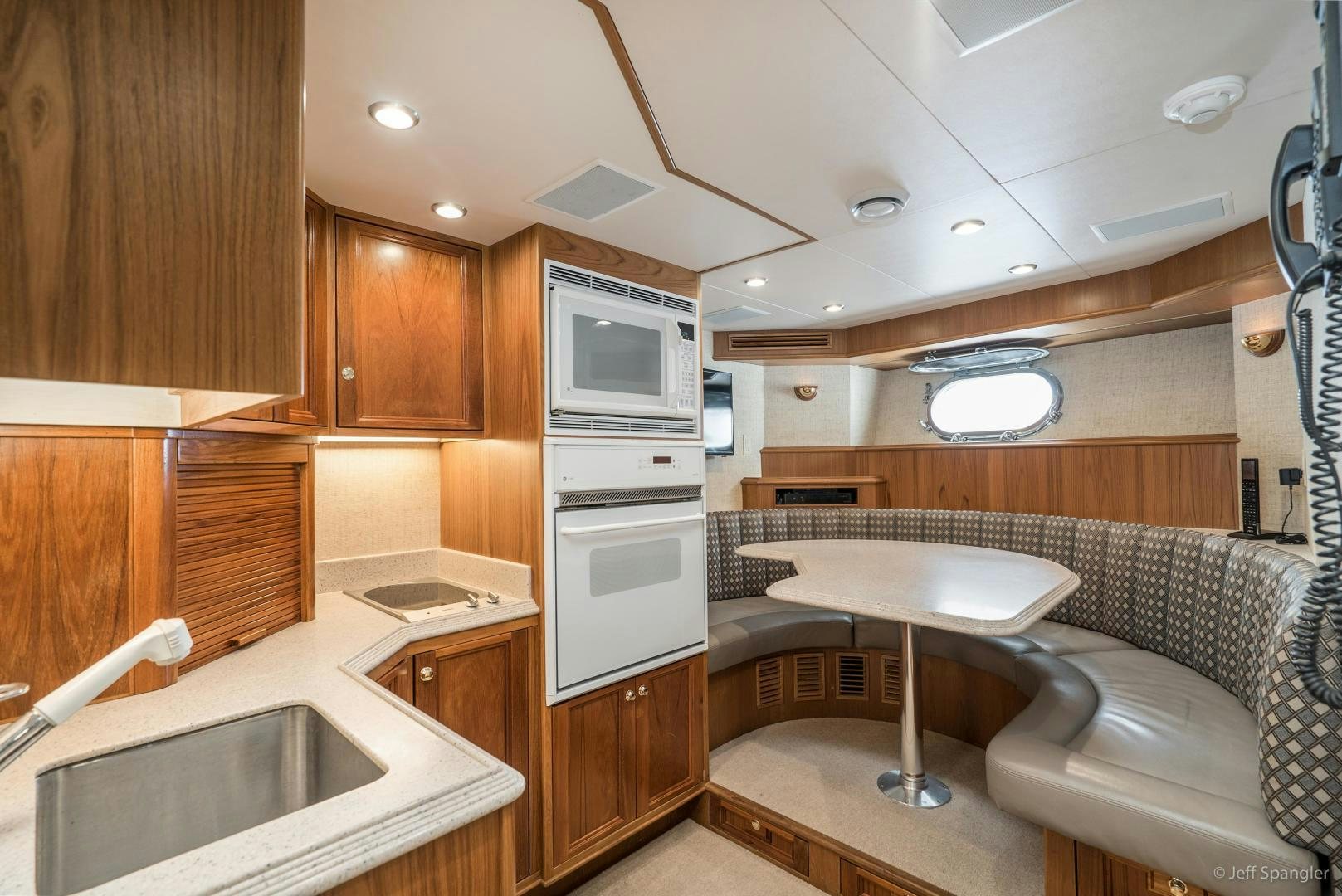 a small kitchen with wooden cabinets aboard LIFE OF RILEY Yacht for Sale