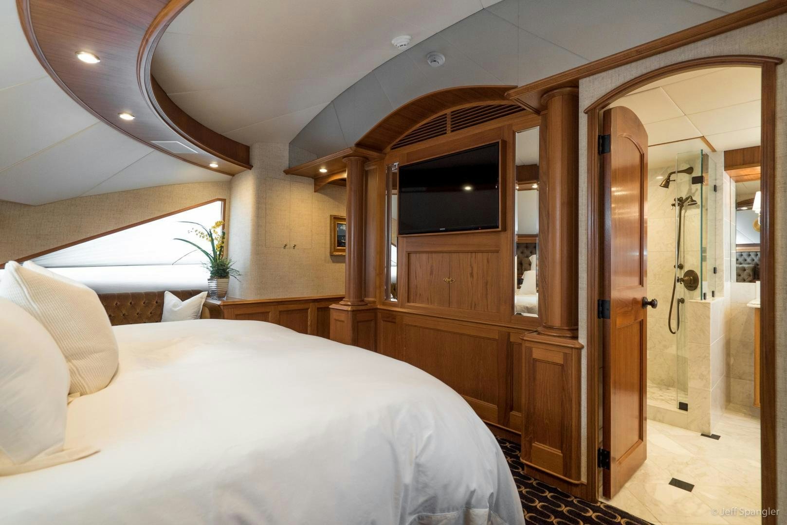 a bedroom with a bed and a closet aboard LIFE OF RILEY Yacht for Sale
