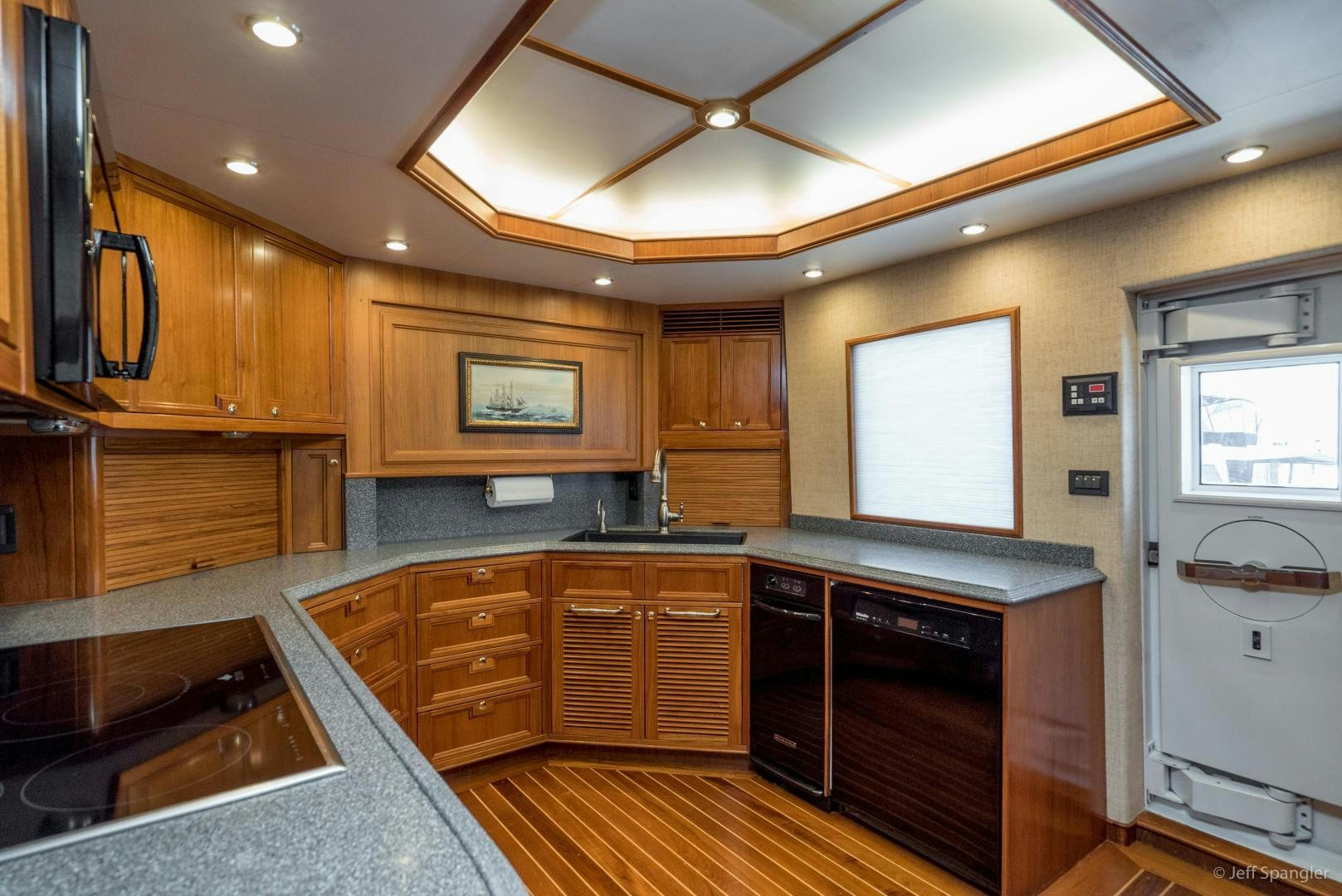 a kitchen with wooden cabinets aboard LIFE OF RILEY Yacht for Sale